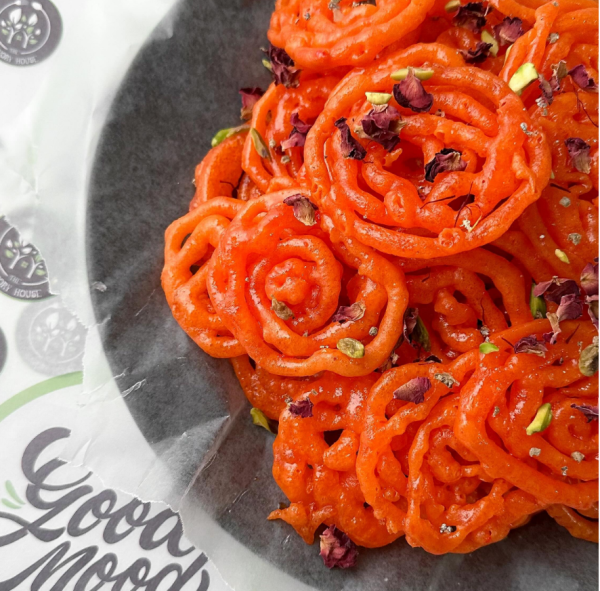 Fresh Jalebis topped with pistachios, rose petals & saffron