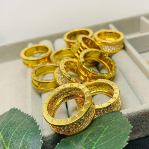 ANEIS aço inoxidável banhado em dourado com detalhes de Acrílico Champanhe.  Bvlgari 9.900kz